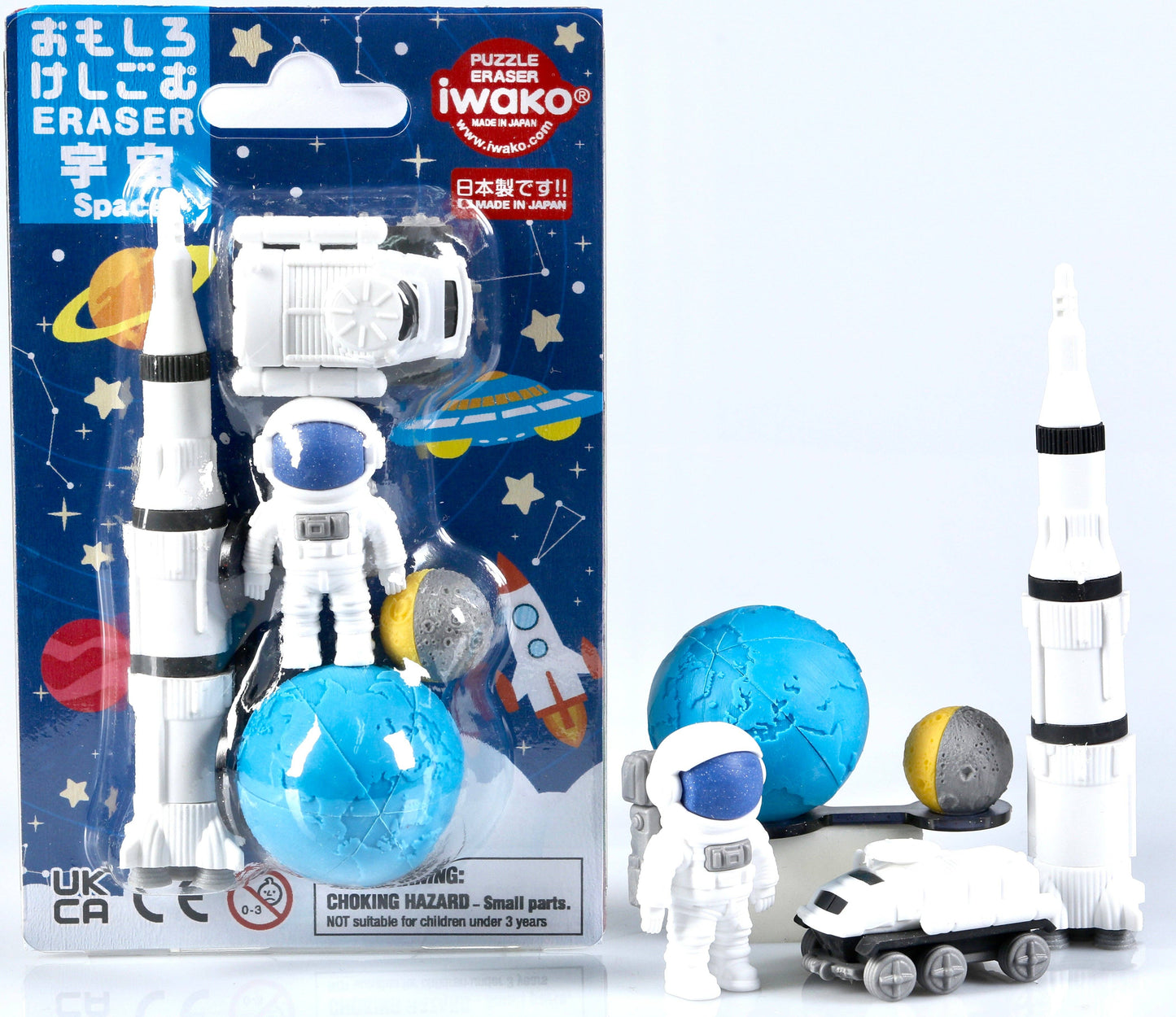 Space-themed eraser toy set with an astronaut figure, rocket, and planets next to its packaging.