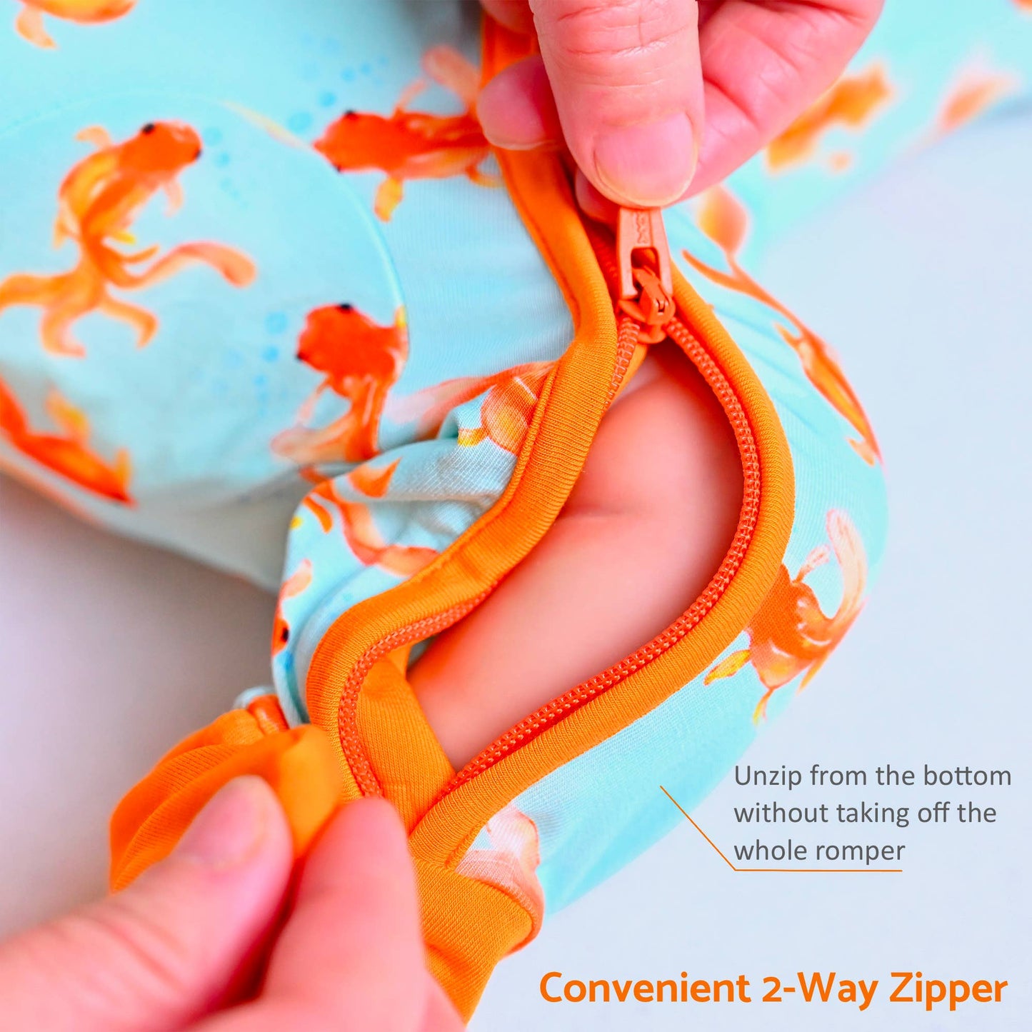 Baby romper with a 2-way zipper being unzipped by hands, with text indicating convenience.