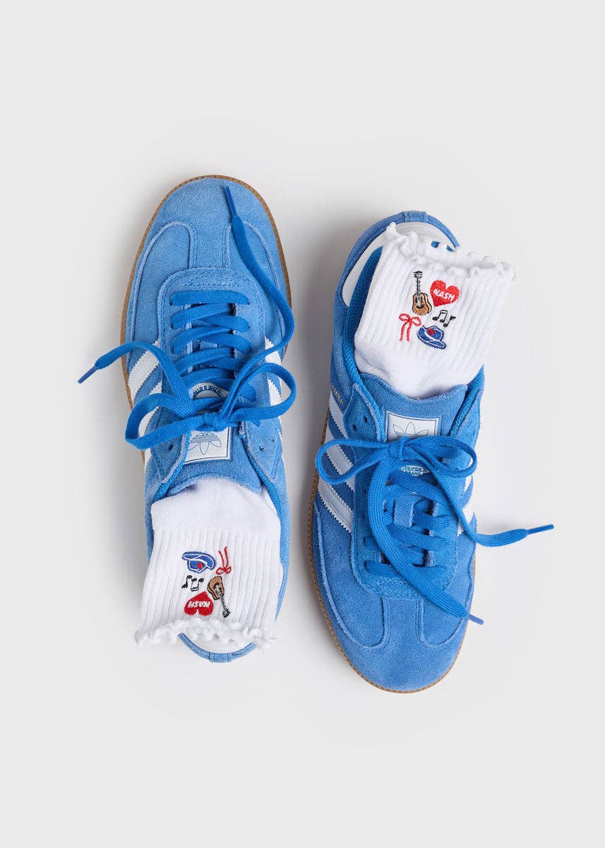 Pair of blue sneakers with white socks featuring cartoon characters on a light gray background