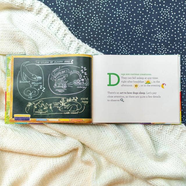 Open book with illustrations and text on a soft fabric background